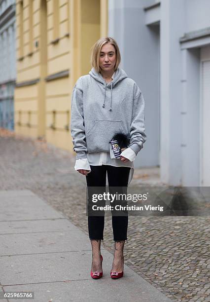 Sonia Lyson wearing red heel pumps manolo blahnik, black cropped denim jeans Zara, grey hoody weekday white blouse weekday, white Furla bag, black...