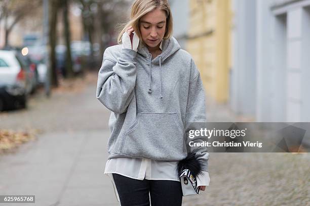 Sonia Lyson wearing black cropped denim jeans Zara, grey hoody weekday white blouse weekday, white Furla bag, black net tights falke on November 26,...