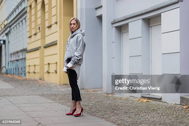 Sonia Lyson wearing red heel pumps manolo blahnik, black cropped denim jeans Zara, grey hoody weekday white blouse weekday, white Furla bag, black...