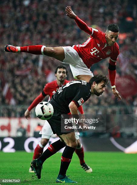 Thiago Bayern Munich heads the ball over Admir Mehmedi of Bayer 04 Leverkusen during the Bundesliga match between Bayern Muenchen and Bayer 04...