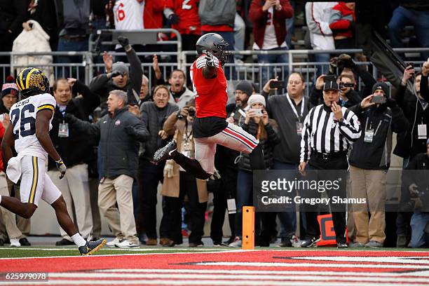 Curtis Samuel of the Ohio State Buckeyes scores the winning touchdown in double overtime against the Michigan Wolverines at Ohio Stadium on November...