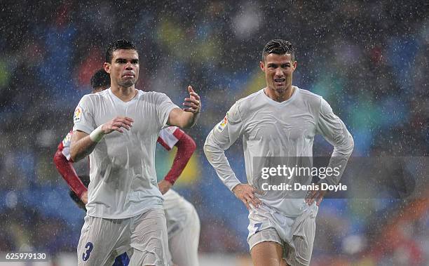 Cristiano Ronaldo of Real Madrid reacts with Pepe during the La Liga match between Real Madrid CF and Real Sporting de Gijon at Estadio Santiago...