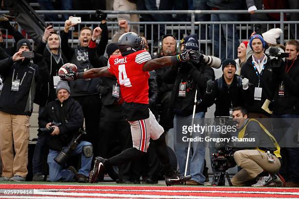 Curtis Samuel of the Ohio State Buckeyes scores the winning touchdown in double overtime against the Michigan Wolverines at Ohio Stadium on November...
