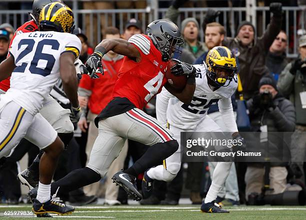 Curtis Samuel of the Ohio State Buckeyes rushes the ball to the end zone to score the game-winning touchdown in overtime against the Michigan...