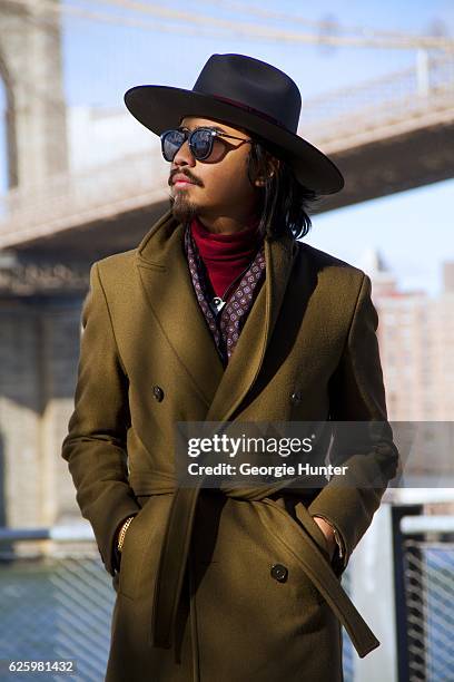 Denny Balmaceda seen wearing red ribbed cotton polo neck turtleneck top by Uniqlo, olive green wool Zara coat with large collar and waist tie,...