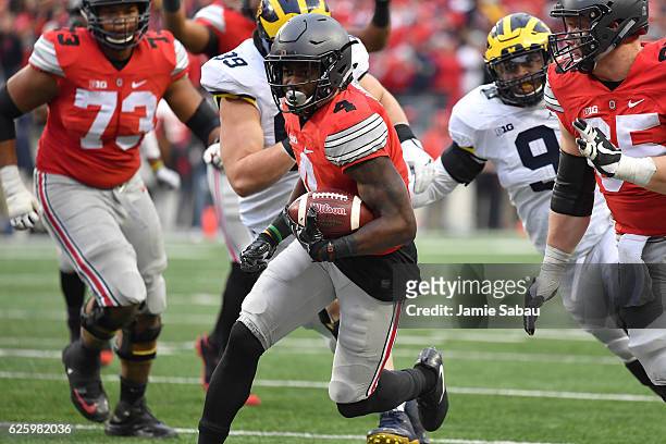 Curtis Samuel of the Ohio State Buckeyes rushes for the game-winning touchdown in overtime against the Michigan Wolverines at Ohio Stadium on...