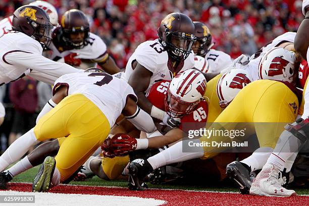 Alec Ingold of the Wisconsin Badgers scores a touchdown in the second quarter against the Minnesota Golden Gophers at Camp Randall Stadium on...