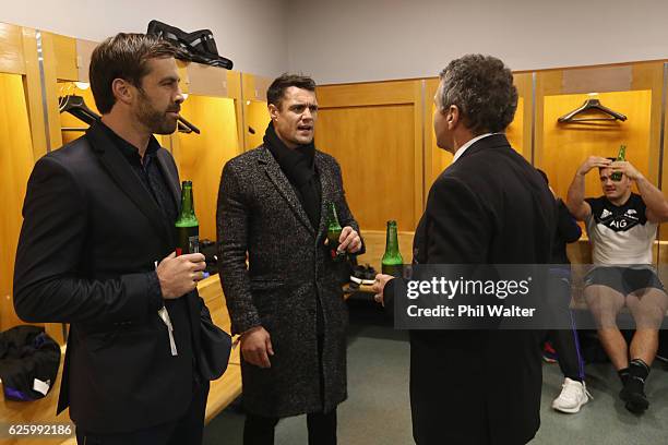 Former All Blacks Dan Carter and Conrad Smith chat with assistant coach Wayne Smith in the dressing room following the international rugby match...