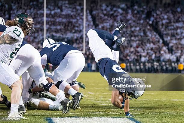 Saquon Barkley of the Penn State Nittany Lions flips into the end zone for a touchdown during the second quarter against the Michigan State Spartans...