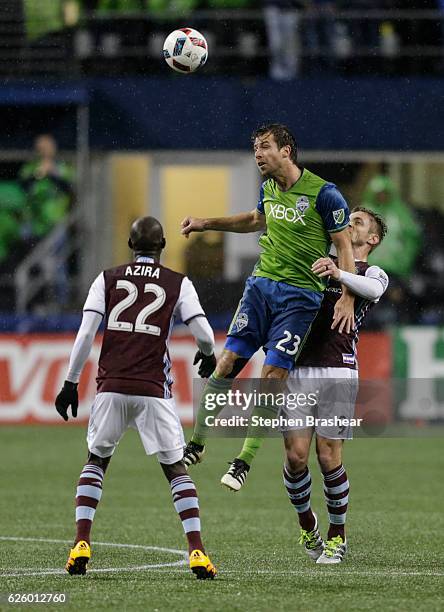 Andreas Ivanschitz of the Seattle Sounders heads the ball as Kevin Doyle of the Colorado Rapids and Michael Azira defend during a match in the first...