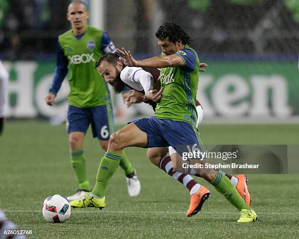 Nelson Valdez of the Seattle Sounders battles Shkelzen Gashi of the Colorado Rapids for the ball during a match in the first leg of the Western...