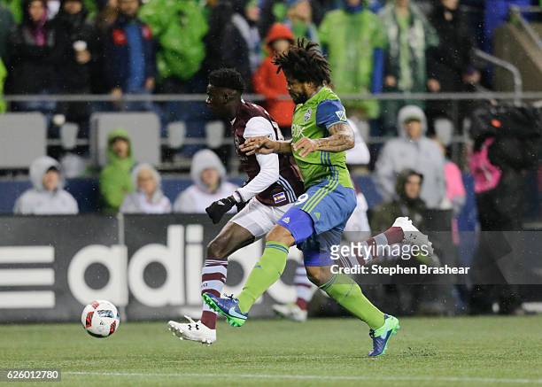 Dominique Badji, left, of the Colorado Rapids and Herculez Gomez of the Seattle Sounders battle for the ball during a match in the first leg of the...