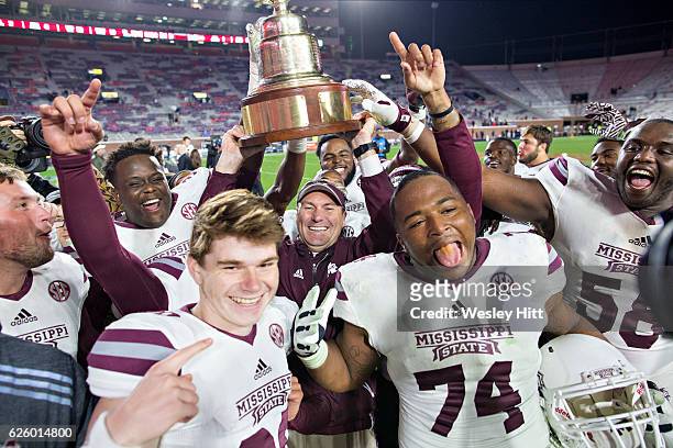 Head Coach Dan Mullen of the Mississippi State Bulldogs celebrates with his team after a game against the Mississippi Rebels at Vaught-Hemingway...