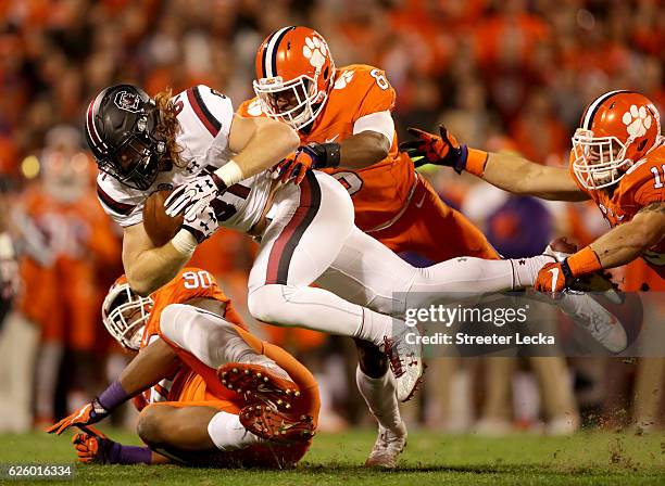 Dorian O'Daniel of the Clemson Tigers tackles Hayden Hurst of the South Carolina Gamecocks during their game at Memorial Stadium on November 26, 2016...