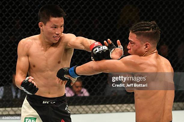 Ben Nguyen punches Geane Herrera in their flyweight bout during the UFC Fight Night event at Rod Laver Arena on November 27, 2016 in Melbourne,...