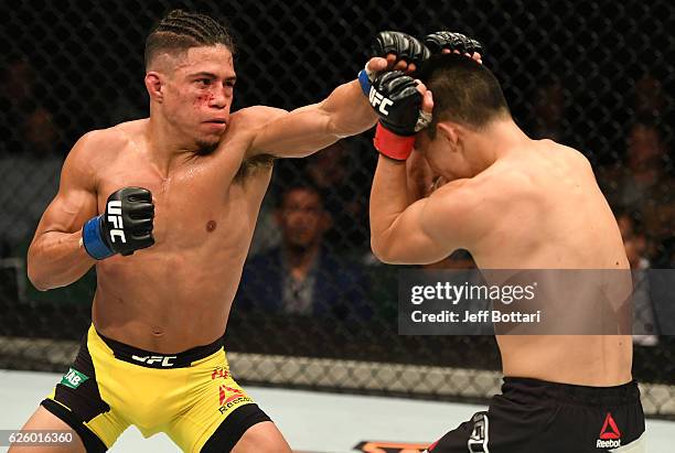 Geane Herrera punches Ben Nguyen in their flyweight bout during the UFC Fight Night event at Rod Laver Arena on November 27, 2016 in Melbourne,...