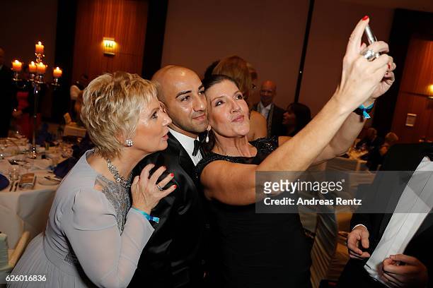 Birgit Lechtermann and Katy Karrenbauer and a guest take a selfie during the charity event dolphin aid gala 'Dolphin's Night' at InterContinental...