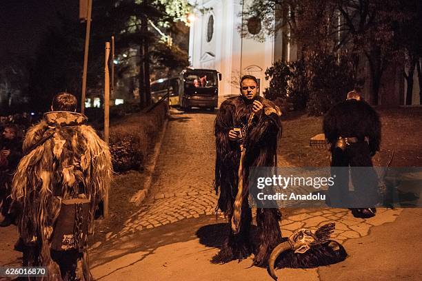 Participants dressed as Krampus walk at the street during Krampus gathering on November 26, 2016 in Zidlochovice , Czech Republic.