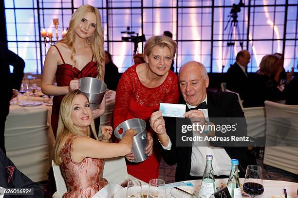 Anna Hiltrop and Andrea Spatzek sell loose during the charity event dolphin aid gala - 'Dolphin's Night' at InterContinental Hotel on November 26,...