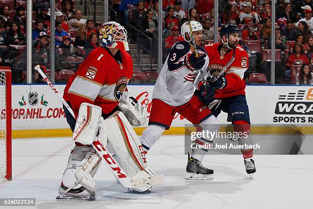 Seth Jones of the Columbus Blue Jackets battles tim Keith Yandle as he tries to get into position in front of goaltender Roberto Luongo of the...