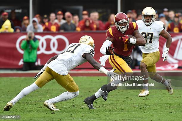 Darreus Rogers of the USC Trojans advances the ball in the third quarter against Jalen Elliott of the Notre Dame Fighting Irish at Los Angeles...