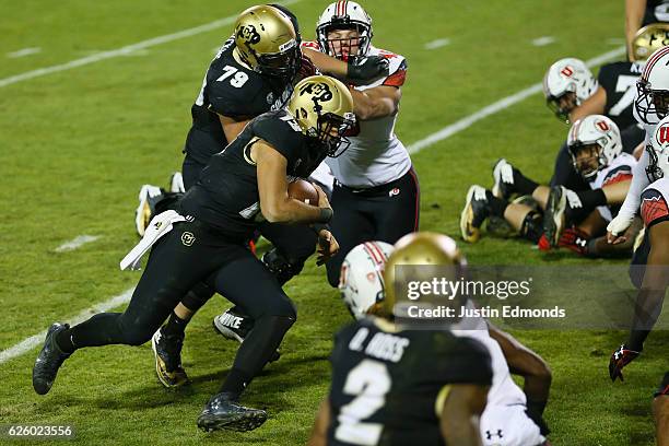 Quarterback Sefo Liufau of the Colorado Buffaloes runs for a touchdown during the first quarter against the Utah Utes at Folsom Field on November 26,...