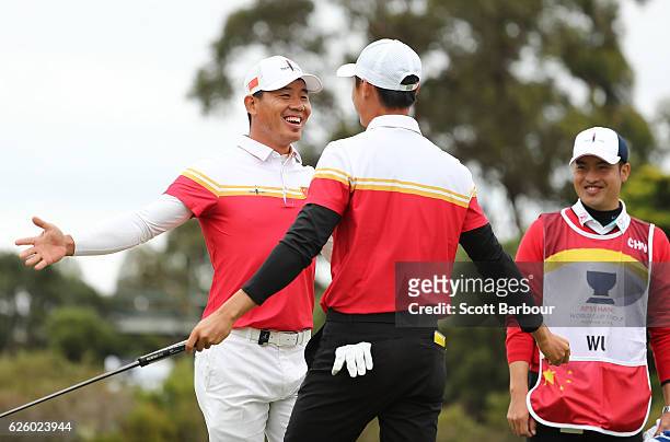 Wu Ashun and Haotong Li of China celebrate a birdie during day four of the World Cup of Golf at Kingston Heath Golf Club on November 27, 2016 in...
