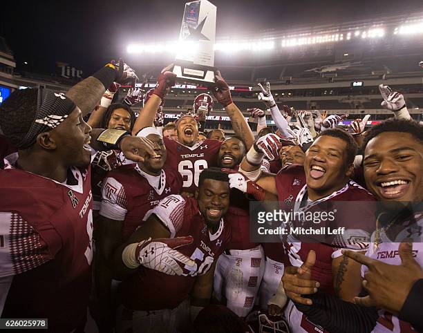 The Temple Owls celebrate with the American Athletic Conference East Division trophy after the game against the East Carolina Pirates at Lincoln...