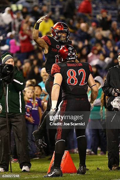 Running back Donnel Pumphrey of the San Diego State Aztecs celebrates with tight end Parker Houston after running a 7 yard touchdown in the second...