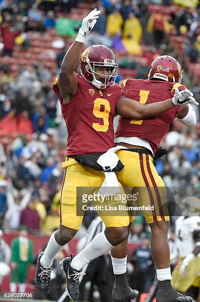 JuJu Smith-Schuster of the USC Trojans celebrates with teammate Darreus Rogers after scoring a touchdown in the fourth quarter against the Notre Dame...