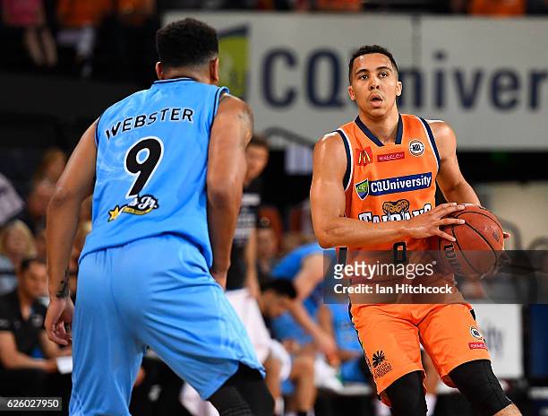 Travis Trice of the Taipans looks to get past Corey Webster of the Breakers during the round eight NBL match between the Cairns Taipans and the New...
