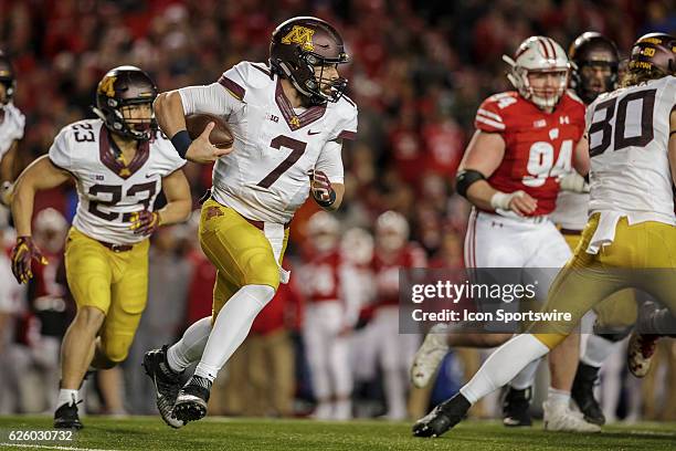 Minnesota Golden Gophers quarterback Mitch Leidner scrambles to of the pocket durning an NCAA Football game between the 6th ranked Wisconsin Badgers...