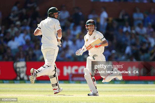 Matt Renshaw and David Warner of Australia run between the wickets during day four of the Third Test match between Australia and South Africa at...