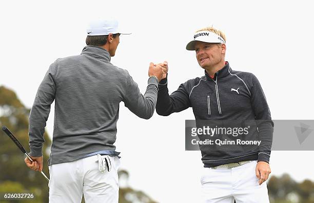 Thorbjorn Olesen and Soren Kjeldsen of Denmark celebrate a birdie during day four of the World Cup of Golf at Kingston Heath Golf Club on November...