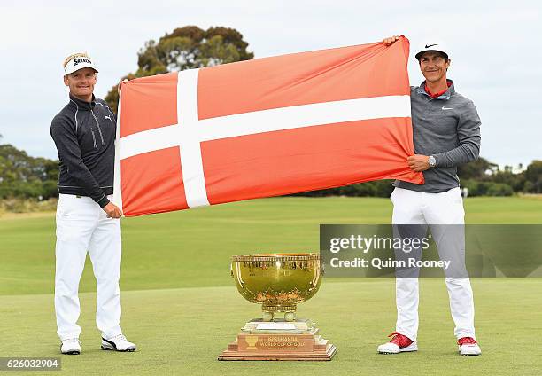 Soren Kjeldsen and Thorbjorn Olesen of Denmark pose with the trophy after winning the tournament during day four of the World Cup of Golf at Kingston...