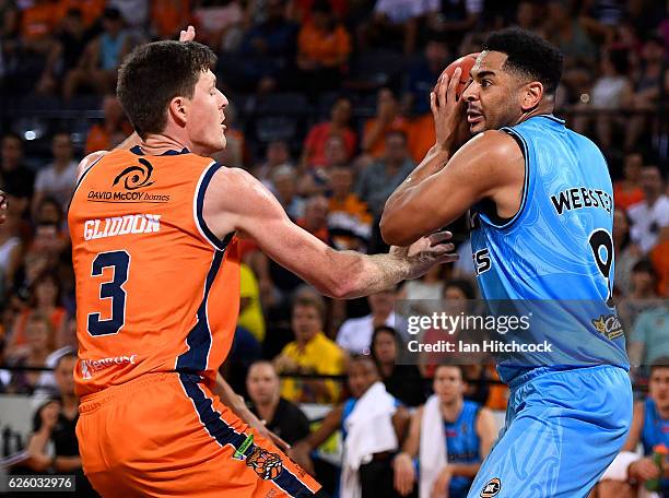 Corey Webster of the Breakers looks to pass the ball past Cam Gliddon of the Taipans during the round eight NBL match between the Cairns Taipans and...