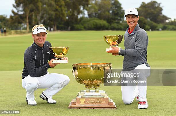 Soren Kjeldsen and Thorbjorn Olesen of Denmark pose with the trophy after winning the tournament during day four of the World Cup of Golf at Kingston...