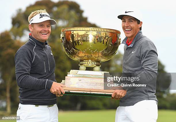 Soren Kjeldsen and Thorbjorn Olesen of Denmark pose with the trophy after winning the tournament during day four of the World Cup of Golf at Kingston...