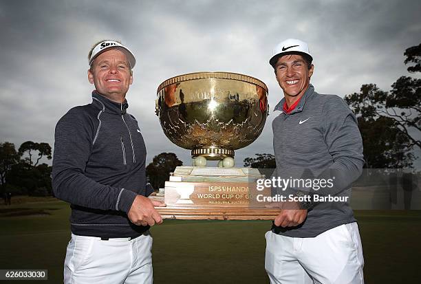 Soren Kjeldsen and Thorbjorn Olesen of Denmark pose with the trophy after winning the tournament during day four of the World Cup of Golf at Kingston...