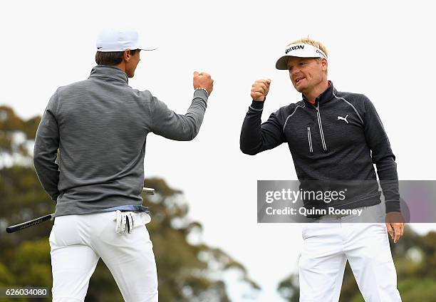 Thorbjorn Olesen and Soren Kjeldsen of Denmark celebrate a birdie during day four of the World Cup of Golf at Kingston Heath Golf Club on November...