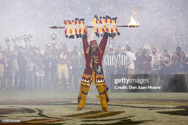 Chief Osceola of the Florida State Seminoles raises the lighted spear at mid-field before the game against the Florida Gators at Doak Campbell...
