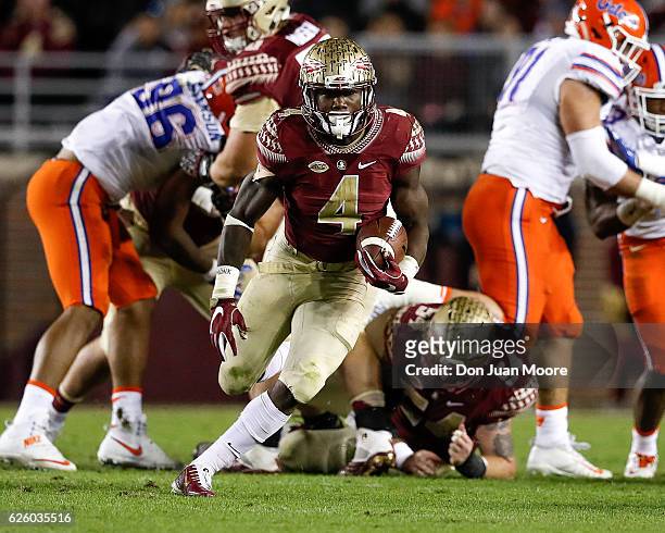 Running back Dalvin Cook of the Florida State Seminoles breaks free up the middle on a running play during the game against the Florida Gators at...