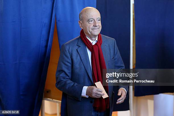Alain Juppe, Mayor of Bordeaux and Les Republicains presidential candidate hopeful votes during the second round of voting in the Republican Party's...