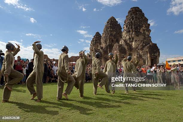 Performers dressed in monkey costumes dance at an ancient temple during the annual "monkey buffet" in Lopburi province, north of Bangkok on November...