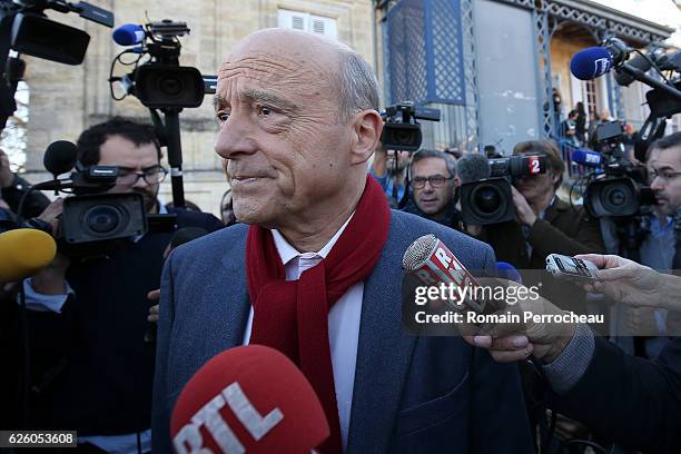 Alain Juppe, Mayor of Bordeaux and Les Republicains presidential candidate hopeful looks on after his votes during the second round of voting in the...