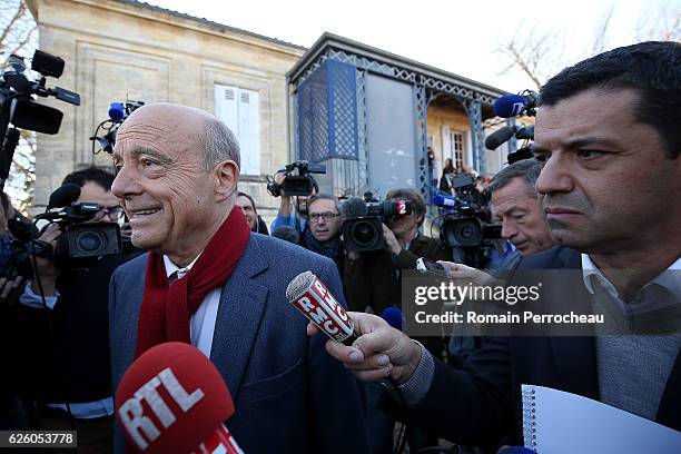 Alain Juppe, Mayor of Bordeaux and Les Republicains presidential candidate hopeful looks on after his votes during the second round of voting in the...