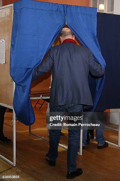 Alain Juppe, Mayor of Bordeaux and Les Republicains presidential candidate hopeful votes during the second round of voting in the Republican Party's...