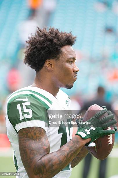 New York Jets Wide Receiver Brandon Marshall holds the football on the field before the start of the NFL football game between the New York Jets and...