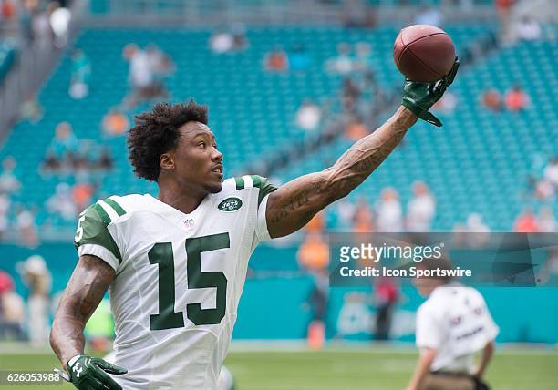 New York Jets Wide Receiver Brandon Marshall practices catches a football with one hand on the field before the start of the NFL football game...