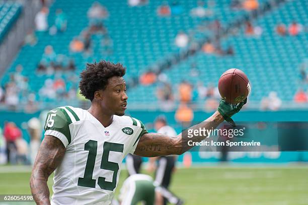 New York Jets Wide Receiver Brandon Marshall practices catches a football with one hand on the field before the start of the NFL football game...